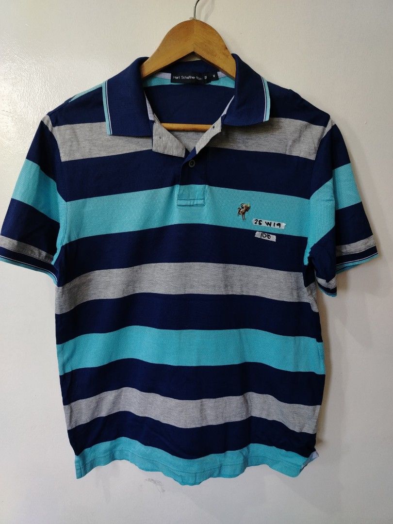 Hart Schaffner Marx Striped Polo Shirt (Category: Tshirts & Polo Shirts ) located in Manila. Submitted by zyclothing03 (Listing ID 1464978006, Image 1). Description: - Brand: Hart Schaffner Marx - Design: Classic multi-color horizontal stripes (navy blue, light blue, and grey) - Details: Small embroidered logo on left chest, standard button placket, ribbed cuffs - Fit/Material: Comfortable fabric, perfect for casual everyday wear - Condition: Exc