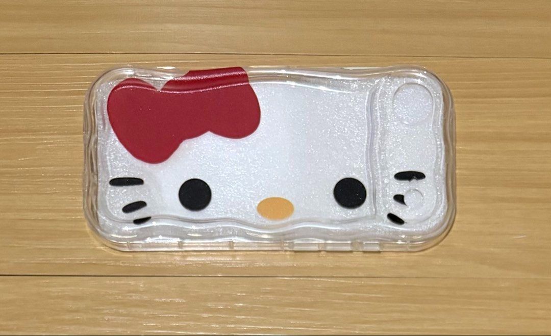 Hello Kitty Face iPhone Air Case (Category: Cases & Sleeves) located in Quezon City. Submitted by garagesale2026 (Listing ID 1465122444, Image 1). Description: - Unused - Product: Kitty Face Phone Case - Compatibility: Specifically designed for iPhone 17 Air - Design: Features iconic Kitty face with signature red bow on a clear, wavy-edge body - Condition: Brand new - Silicone / Rubber material - Style: Cute, trendy, and perfect for Sanrio fans.