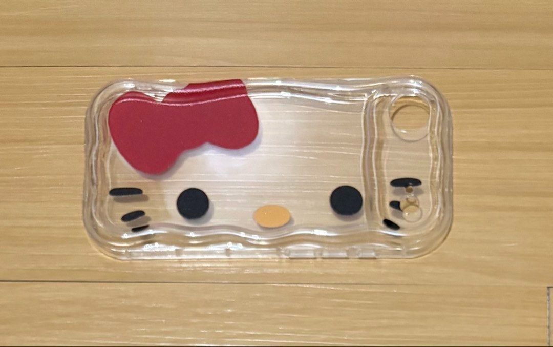 Hello Kitty Face iPhone Air Case (Category: Cases & Sleeves) located in Quezon City. Submitted by garagesale2026 (Listing ID 1465122444, Image 2). Description: - Unused - Product: Kitty Face Phone Case - Compatibility: Specifically designed for iPhone 17 Air - Design: Features iconic Kitty face with signature red bow on a clear, wavy-edge body - Condition: Brand new - Silicone / Rubber material - Style: Cute, trendy, and perfect for Sanrio fans.