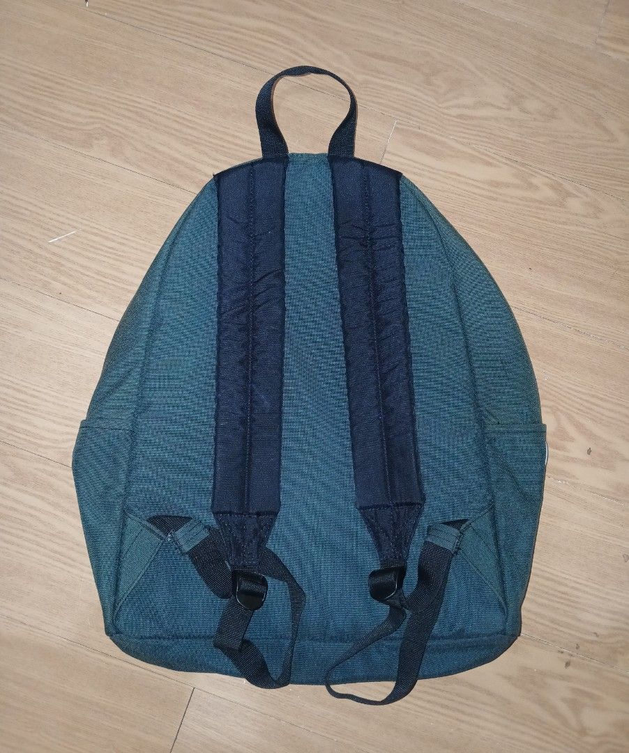 Helly Hansen Green Backpack Daypack (Category: Backpacks) located in Daraga. Submitted by thethriftcity2024 (Listing ID 1465169517, Image 2). Description: - Brand: Helly Hansen - Color: Dark green with white zippers and dark blue lining - Features: Front zip pocket, adjustable padded straps, top grab handle - Details: Classic retro embroidered logo patch on front - Condition: Clean interior, all zippers fully functional - Origin: Made in Vietnam 