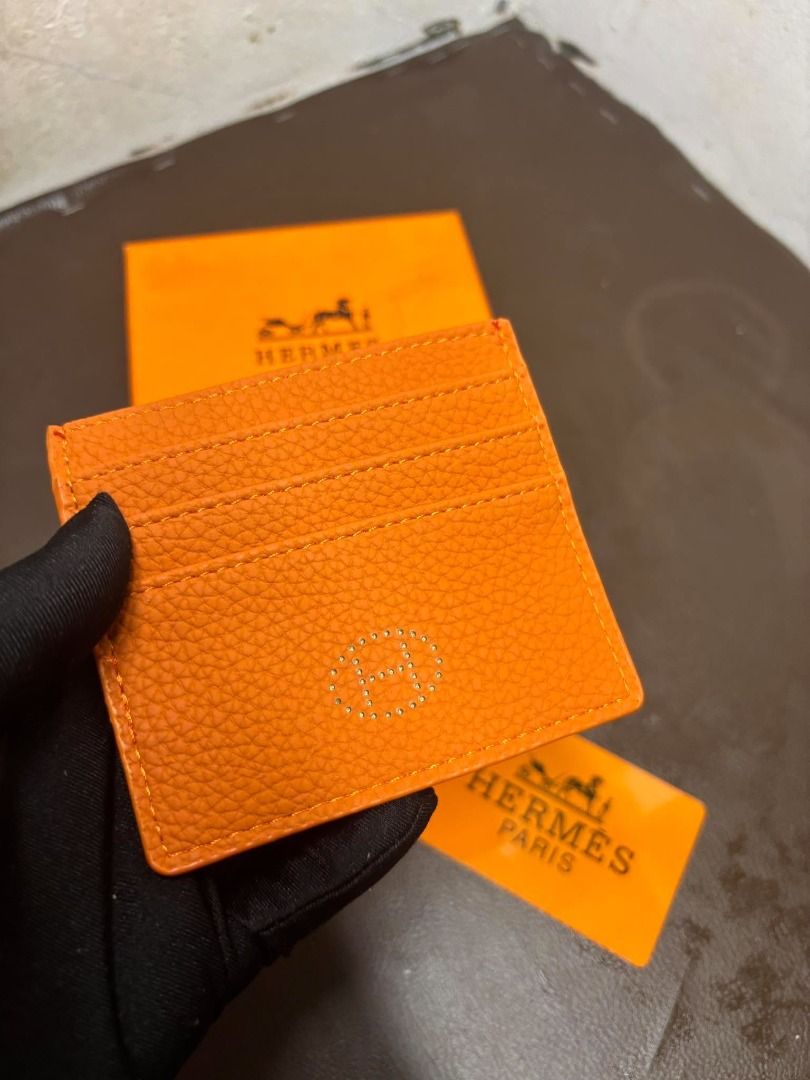 Hermès Leather Card Holder | Orange | With Box (Category: Wall Decor) located in Bacoor. Submitted by fafofa (Listing ID 1465102556, Image 2). Description: Hermès orange textured leather card holder featuring an embossed Hermès logo and a clean, compact design. • Orange textured leather • Embossed Hermès logo • Compact card holder design • Includes Hermès box • Includes branded card.