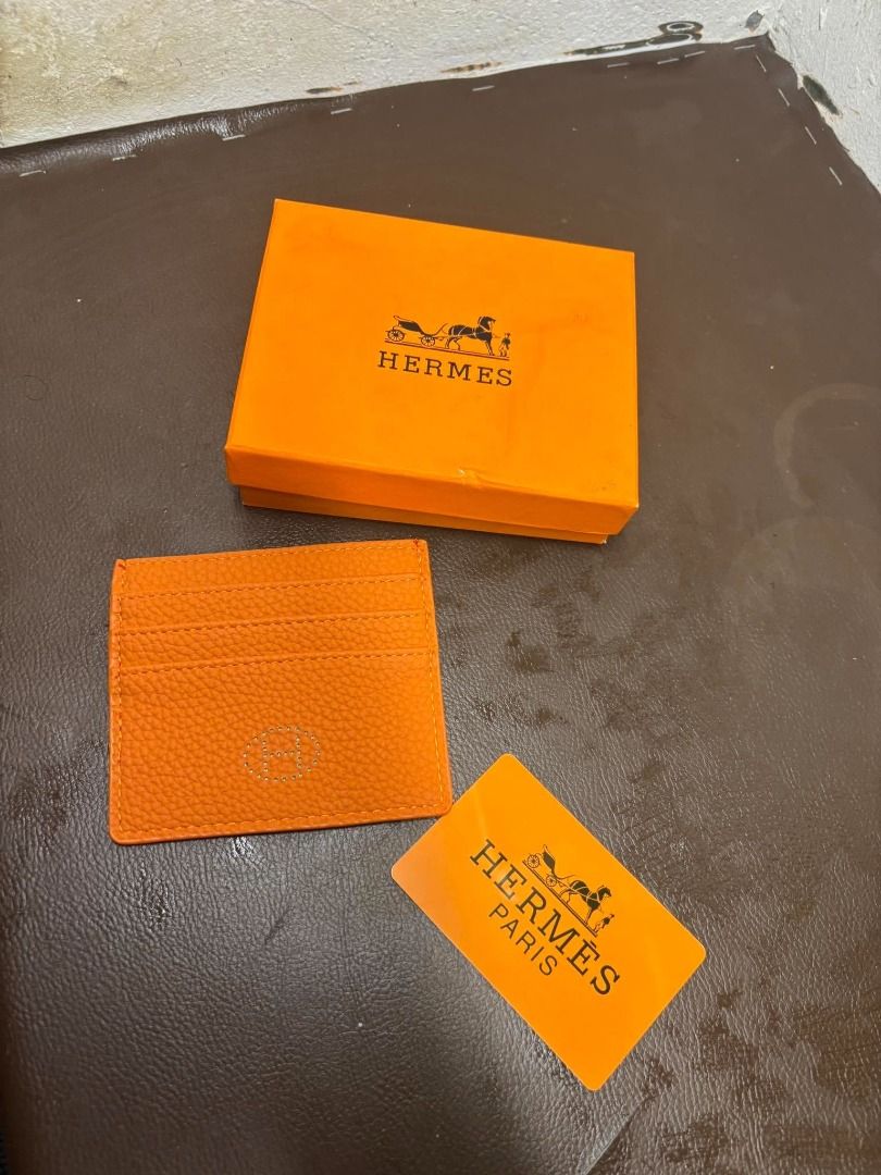 Hermès Leather Card Holder | Orange | With Box (Category: Wall Decor) located in Bacoor. Submitted by fafofa (Listing ID 1465102556, Image 3). Description: Hermès orange textured leather card holder featuring an embossed Hermès logo and a clean, compact design. • Orange textured leather • Embossed Hermès logo • Compact card holder design • Includes Hermès box • Includes branded card.