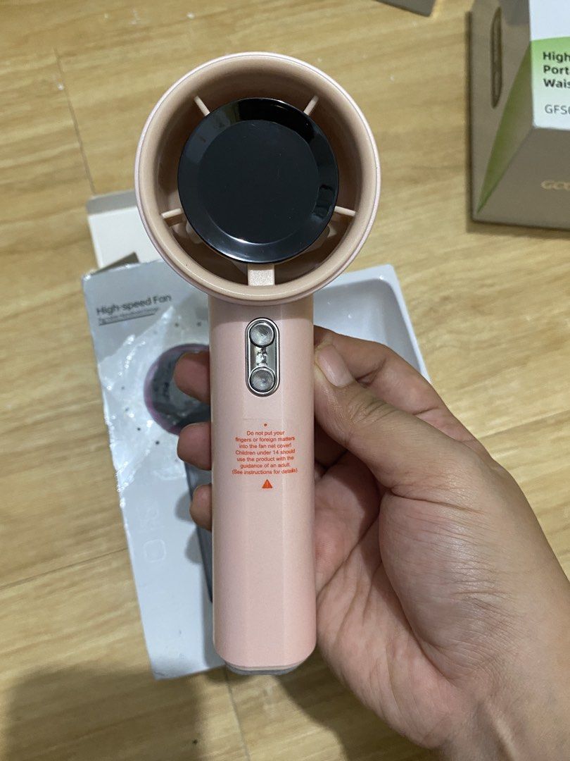 High-speed Portable Handheld Fan Pink with LED Screen (Category: Fans) located in Iloilo. Submitted by angelenepe01084 (Listing ID 1465100555, Image 1). Description: - Color: Stylish Pink - Speed: 100-speed adjustable air volume - Battery: Large 4000mAh built-in capacity - Safety: Includes handle switch lock to prevent accidental activation - Condition: Brand new in original box with protective plastic wrap - Ideal for commuting, travel, and dail