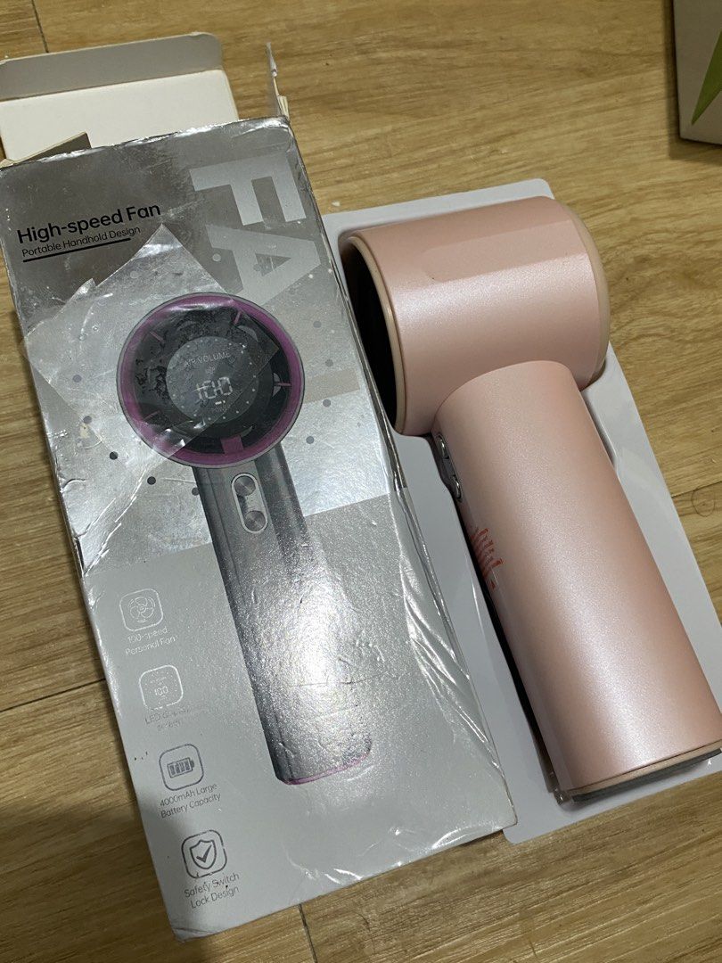 High-speed Portable Handheld Fan Pink with LED Screen (Category: Fans) located in Iloilo. Submitted by angelenepe01084 (Listing ID 1465100555, Image 3). Description: - Color: Stylish Pink - Speed: 100-speed adjustable air volume - Battery: Large 4000mAh built-in capacity - Safety: Includes handle switch lock to prevent accidental activation - Condition: Brand new in original box with protective plastic wrap - Ideal for commuting, travel, and dail