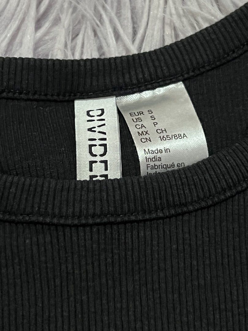 H&M Divided Black Ribbed Tank Top Size S (Category: Sleeveless) located in Cabanatuan. Submitted by imported2023 (Listing ID 1465078719, Image 2). Description: - Brand/Model: H&M Divided - Color: Black - Size: S (EUR S, US S, CN 165/88A) - Material: Soft, stretchy cotton - Style: Fitted racerback with high neckline - Condition: Excellent, clean, no flaws - Made in: India - Perfect go-to basic for everyday styling.