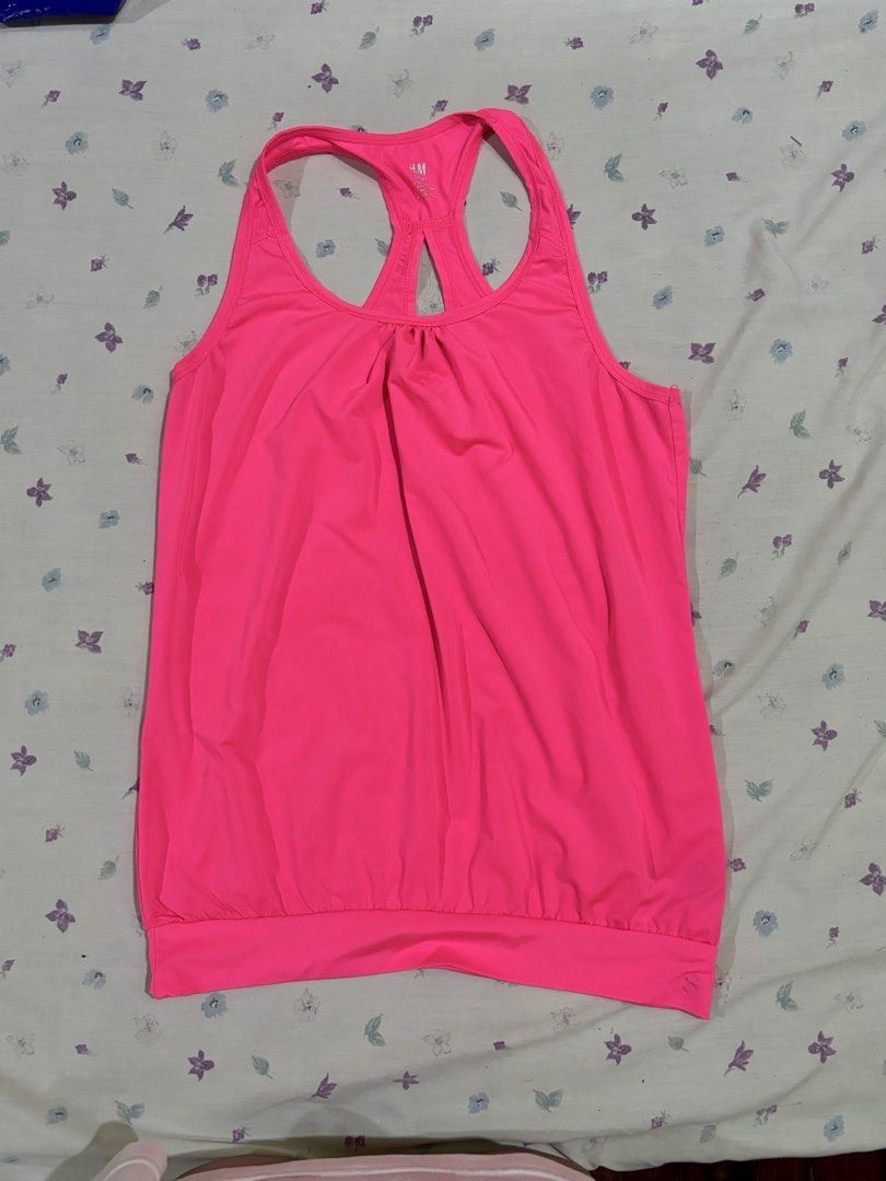H&M Neon Pink Workout Tank Top (Category: Activewear) located in Mandaluyong City. Submitted by judened (Listing ID 1465035172, Image 1). Description: - Brand/Item: H&M Bright Pink Workout Tank Top - Design: Racerback with stylish back cutout and gathered neckline - Fit: Relaxed drape with a wide fitted bottom hem for a secure hold - Material: Lightweight, breathable fabric - Ideal For: Gym sessions and outdoor runs.