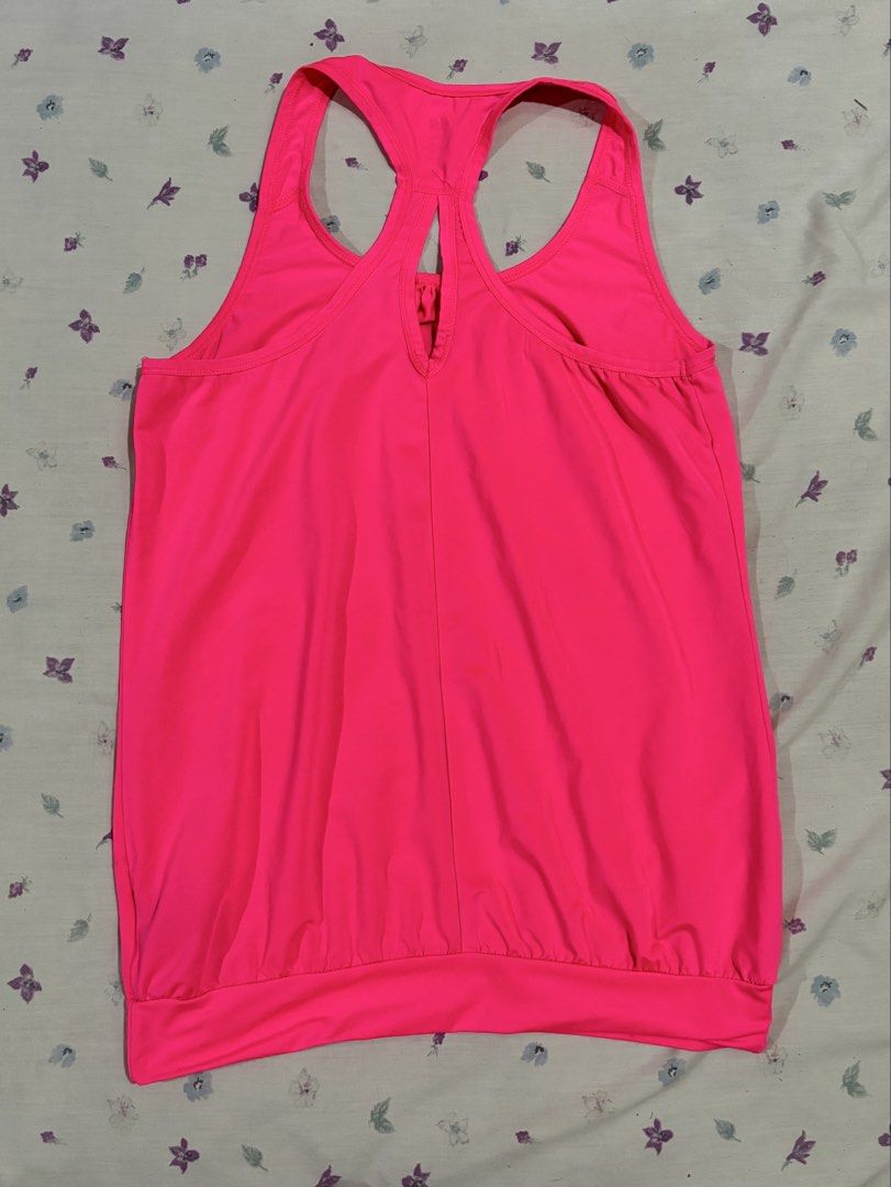 H&M Neon Pink Workout Tank Top (Category: Activewear) located in Mandaluyong City. Submitted by judened (Listing ID 1465035172, Image 2). Description: - Brand/Item: H&M Bright Pink Workout Tank Top - Design: Racerback with stylish back cutout and gathered neckline - Fit: Relaxed drape with a wide fitted bottom hem for a secure hold - Material: Lightweight, breathable fabric - Ideal For: Gym sessions and outdoor runs.