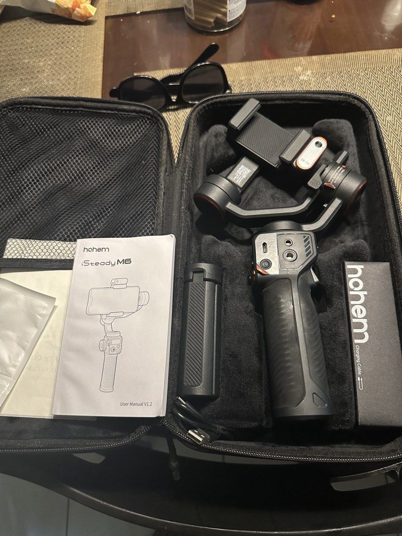 Hohem iSteady M6 Smartphone Gimbal Stabilizer (Category: Gimbals & Stabilizers ) located in Manila. Submitted by olxph_jeffr6014 (Listing ID 1465055235, Image 2). Description: - Model: Hohem iSteady M6 3-Axis Smartphone Gimbal Stabilizer Kit - Condition: Clean, powers on normally, but, NEED TO REPLACE LCD - Inclusions: Main gimbal unit, tripod stand, charging cable box, and manual booklet - Storage: Original hardshell carry case with custom molde