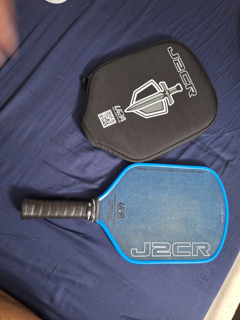 Honolulu J2CR Paddle with Case (Category: Racket and Ball Sports) located in Quezon City. Submitted by pikapickle (Listing ID 1465075449, Image 1). Description: - Model: Honolulu Pickleball Company J2CR - Color: Bright blue with black grip tape - Certification: UPA pro certified - Features: Textured surface for superior spin control - Included: Matching black protective carrying case with zip closure and wrist strap - Ideal for: Intermediate and 