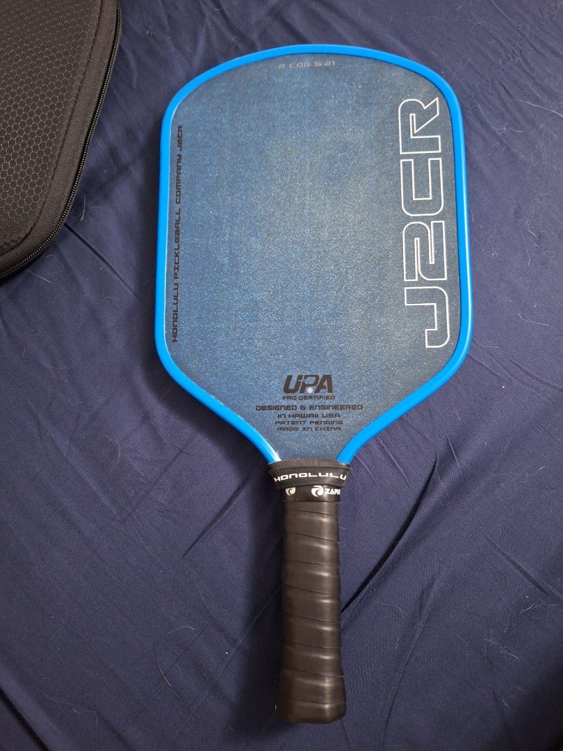Honolulu J2CR Paddle with Case (Category: Racket and Ball Sports) located in Quezon City. Submitted by pikapickle (Listing ID 1465075449, Image 2). Description: - Model: Honolulu Pickleball Company J2CR - Color: Bright blue with black grip tape - Certification: UPA pro certified - Features: Textured surface for superior spin control - Included: Matching black protective carrying case with zip closure and wrist strap - Ideal for: Intermediate and 