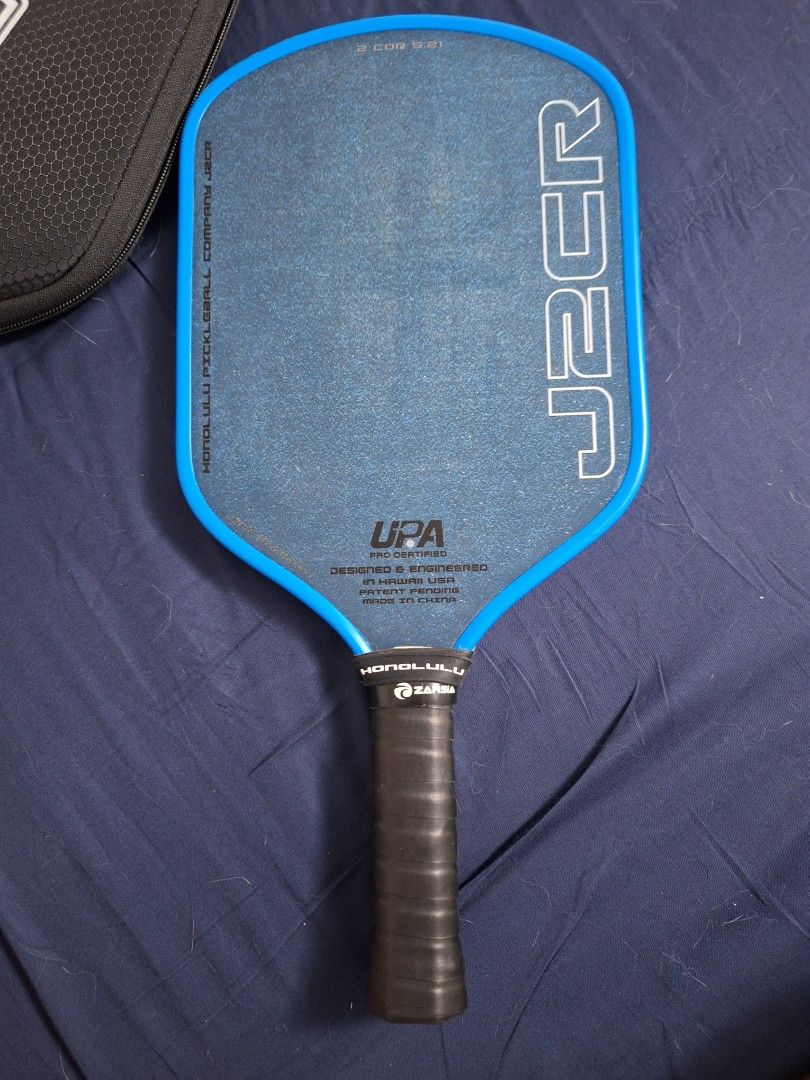 Honolulu J2CR Paddle with Case (Category: Racket and Ball Sports) located in Quezon City. Submitted by pikapickle (Listing ID 1465075449, Image 3). Description: - Model: Honolulu Pickleball Company J2CR - Color: Bright blue with black grip tape - Certification: UPA pro certified - Features: Textured surface for superior spin control - Included: Matching black protective carrying case with zip closure and wrist strap - Ideal for: Intermediate and 