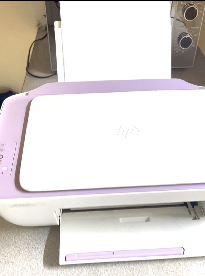 HP Printer White and Purple Desktop Model (Category: Printers, Scanners & Copiers) located in Manila. Submitted by mystitch888 (Listing ID 1464981369, Image 1). Description: - Model: Compact HP desktop printer - Color: Stylish white and light purple - Design: Top paper feeder with front output tray - Includes: Attached power cable - Condition: Clean exterior finish, space-saving size ideal for any desk.