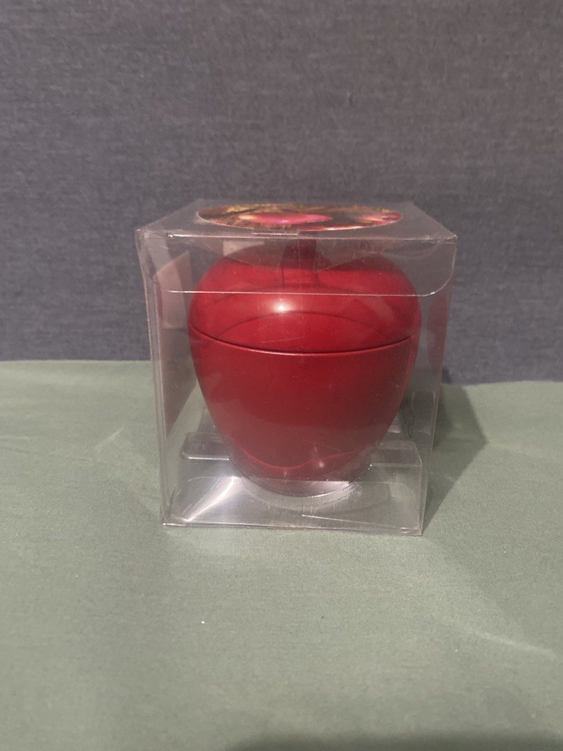 IKEA Apple-Shaped Scented Candle in Tin (Category: Home Fragrance) located in Pasig City. Submitted by nakamuraka (Listing ID 1464982435, Image 3). Description: - Brand: IKEA (Vinter 2021 Collection by Malin Gyllensvaan) - Design: Red apple-shaped metal tin container with lid - Fragrance: Apple, cinnamon, and vanilla - Burn time: 24 hours - Condition: Brand new, still sealed in original clear plastic display box - Ideal for holiday home decor or 