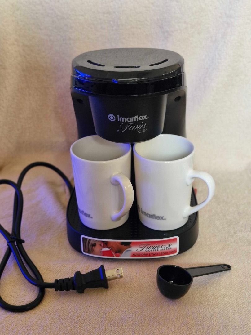 Imarflex Twin Cup Coffee Maker (Category: Coffee Machines & Makers) located in Davao. Submitted by j_guitarist (Listing ID 1465025403, Image 3). Description: - Brand: Imarflex - Brews two 125ml cups simultaneously with an auto-drip system - Includes two matching white ceramic mugs - Comes with a black measuring spoon - Original box included - Excellent working condition - Perfect for couples or individuals looking for a quick, compact brew.