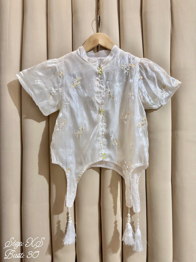 Improved Cheongsam Blouse (Category: Blouses) located in Manila. Submitted by glamstylemnl (Listing ID 1465145229, Image 1). Description: ♡ SIZE: XS ♡ BUST: 30 ♡ Swipe left to see the actual color & details ♡ chinese style / floral embroidered / front button closures / tassel at hem / missing 1 button ♡ HQ • 9/10 ♡ Ready to wear 👚.
