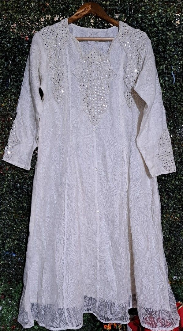 Indian White Embroidered Kurti with Mirror Work (Category: Blouses) located in Batangas. Submitted by yanaspreloved1 (Listing ID 1464989227, Image 1). Description: - Color: White - Style: Traditional ethnic wear long-sleeve kurti - Detailing: Heavy all-over embroidery with mirror work and pearl bead accents on neckline, shoulders, and cuffs - Design: Sheer panel hem and full front button placket - Fabric: Lightweight and comfortable.