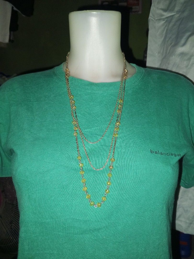 INDIVI Multi-Strand Yellow Beaded Necklace (Category: Necklaces) located in Magalang. Submitted by zeiansoria64090 (Listing ID 1464980508, Image 1). Description: - Brand: INDIVI - Design: Multi-strand layered necklace with gold-tone chains, textured metal links, and yellow faceted beads - Closure: Secure clasp with attached INDIVI brand tag - Style: Versatile accessory, great for layering or elevating a simple top.