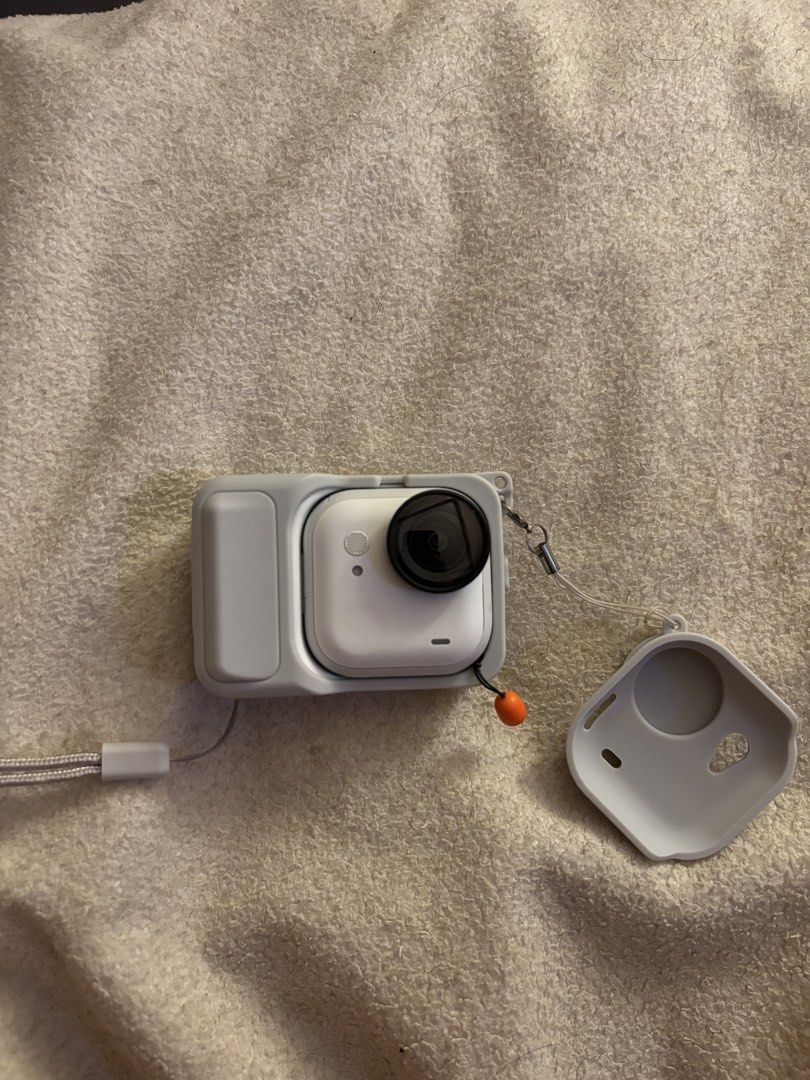 Insta360 GO ultra Action Camera with Case and Lanyard (Category: Cameras) located in Pasig City. Submitted by heyahnggg (Listing ID 1464978076, Image 3). Description: - Model: Insta360 GO Ultra (White) - Condition: Fully functional, ready for vlogging and outdoor shooting - Included Accessories: Protective grey silicone casing, detachable lens cover, box, charger, screen protector, tripod, and matching grey neck lanyard - Key Features: Ultra-comp