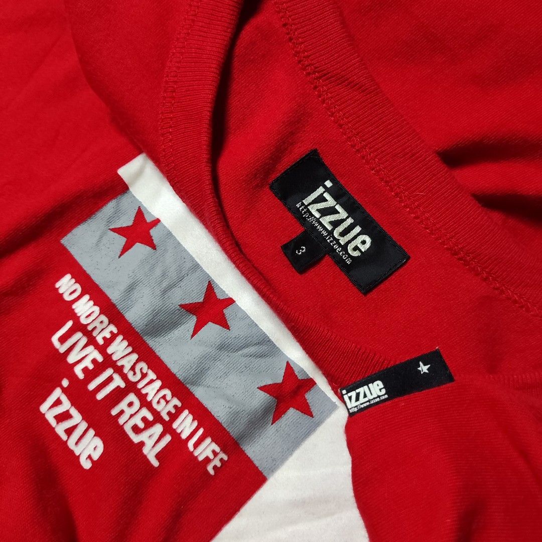 Izzue Rampage Red T-Shirt (Category: Tshirts & Polo Shirts ) located in Taguig. Submitted by althriftdailyloots94 (Listing ID 1465072360, Image 2). Description: - Brand/Style: Authentic Izzue bright red t-shirt with short sleeves and classic crew neck - Design: Large white and grey front graphic featuring 'RAMPAGE' text, motivational slogan, and red star accents - Fit & Fabric: Relaxed everyday fit made from soft, comfortable cotton - Details: In