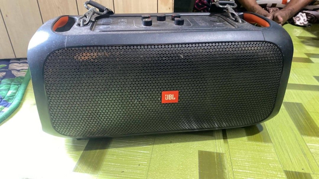 JBL PartyBox On-The-Go Portable Bluetooth Speaker (Category: Soundbars, Speakers & Amplifiers) located in Manila. Submitted by aubrey11.phoenix (Listing ID 1465106511, Image 1). Description: - Authentic JBL PartyBox On-The-Go wireless party speaker in classic black - Powerful sound with built-in top control knobs for easy audio adjustments - Equipped with sturdy shoulder strap clips and vibrant orange accent handles for portability - Heavy-duty b