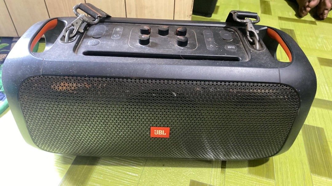 JBL PartyBox On-The-Go Portable Bluetooth Speaker (Category: Soundbars, Speakers & Amplifiers) located in Manila. Submitted by aubrey11.phoenix (Listing ID 1465106511, Image 2). Description: - Authentic JBL PartyBox On-The-Go wireless party speaker in classic black - Powerful sound with built-in top control knobs for easy audio adjustments - Equipped with sturdy shoulder strap clips and vibrant orange accent handles for portability - Heavy-duty b