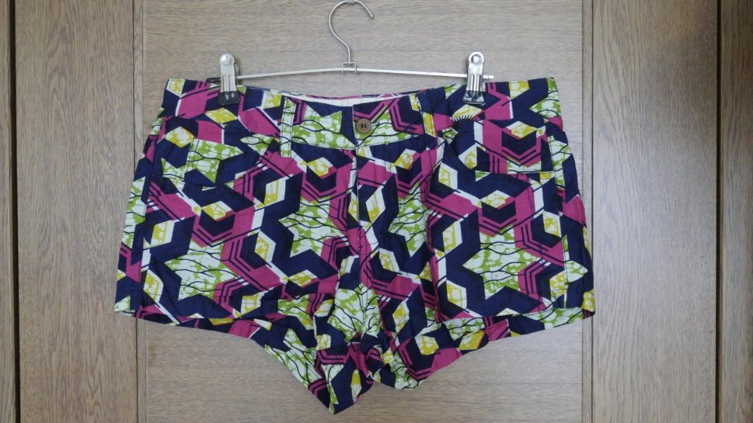 Jekkah African Print Wax Shorts Geometric Pattern (Category: Shorts) located in Taguig. Submitted by spaula76 (Listing ID 1465008402, Image 2). Description: - Brand: Jekkah - Material: Vibrant African wax print fabric - Design: Bold geometric pattern in pink, navy blue, and lime green - Features: Button closure, belt loops, and front/back pockets - Details: Authentic Jekkah cloth label stitched above the right back pocket - Style: Colorful statem