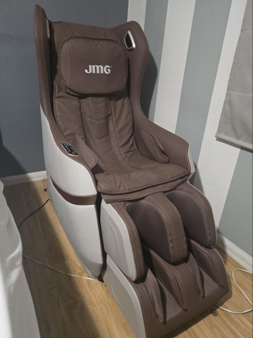 JMG Massage Chair (Category: Massage Devices) located in Pasig City. Submitted by igotfat (Listing ID 1465012047, Image 1). Description: - Brown and white JMG massage chair - Built-in control panel conveniently located on the armrest - Padded headrest featuring the clear brand logo - Integrated foot and calf massage sections at the front - Includes power cord - Great for unwinding and relaxing at home after a long workday.