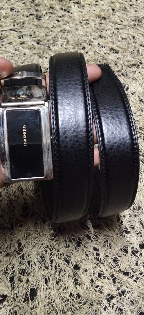 Jorengio Black Leather Ratchet Belt (Category: Belts) located in Paranaque City. Submitted by michael-08 (Listing ID 1465168559, Image 1). Description: - Brand: Jorengio - Material: Black leather with textured finish and contrast stitching - Buckle: Silver and black automatic ratchet buckle with vertical brand inscription - Fit: Track system on the back for easy micro-adjustments - Condition: Brand new / Excellent quality NO ISSUE GOOD CONDITION 