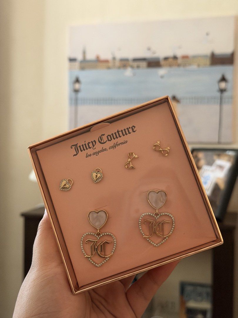 Juicy Couture Heart and Bow Earring Set (Category: Earrings) located in Quezon City. Submitted by ljdgx (Listing ID 1465018066, Image 3). Description: - Brand: Juicy Couture earring set - Condition: Brand new, unworn, in original presentation box - Design: Gold-tone hardware with rhinestone accents, mother-of-pearl look details, and iconic JC monogram logos - Variety: Multiple pairs included featuring dangling hearts, miniature padlocks, and deli
