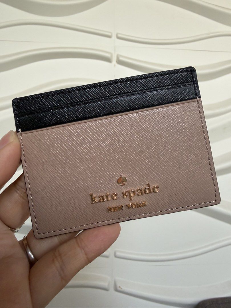 Kate Spade New York Card Holder (Category: Wallets & Card holders) located in Las Pinas. Submitted by cheapsomething (Listing ID 1464989312, Image 3). Description: - Authentic Kate Spade card holder - Elegant black and warm taupe colorway - Durable Saffiano leather texture - Signature gold-foil lettering on the front - Multiple card slots on both sides - Compact and slim size, ideal for daily use - Impeccable clean edges and neat stitching - No t