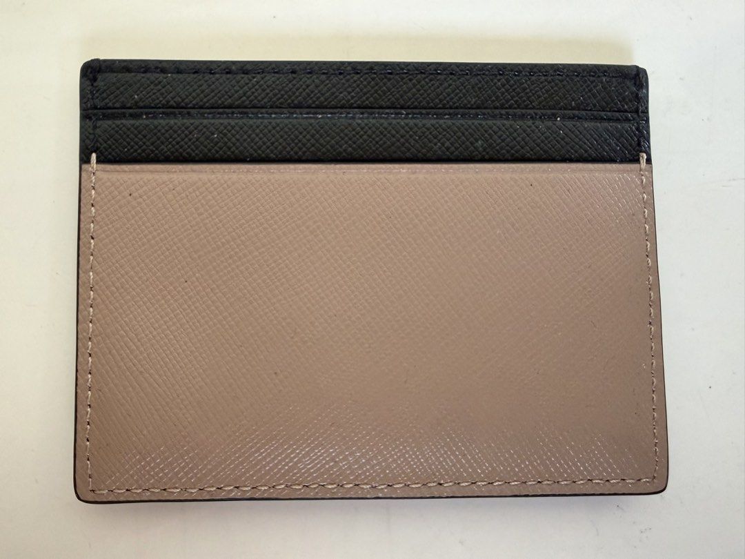 Kate Spade New York Card Holder (Category: Wallets & Card holders) located in Las Pinas. Submitted by cheapsomething (Listing ID 1464989312, Image 2). Description: - Authentic Kate Spade card holder - Elegant black and warm taupe colorway - Durable Saffiano leather texture - Signature gold-foil lettering on the front - Multiple card slots on both sides - Compact and slim size, ideal for daily use - Impeccable clean edges and neat stitching - No t