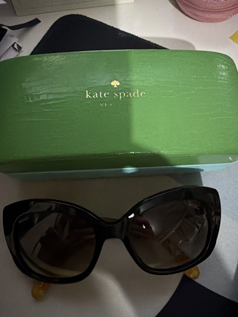 Kate Spade Sunglasses with Green Hard Case (Category: Sunglasses & Eyewear) located in Paranaque City. Submitted by fabmommy (Listing ID 1465146416, Image 1). Description: - Brand: Kate Spade - Style: Oversized cat-eye - Color: Classic black frames with gradient lenses - Condition: Flawless, clean frames and lenses - Inclusion: Original bright green hard case with gold logo lettering.