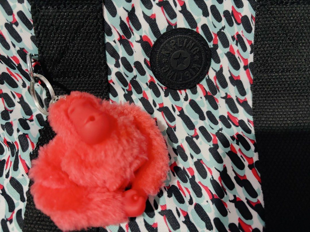 Kipling MINTA Abstract Print Shoulder/Sling Bag 💯 ORIGINAL (Category: Shoulder Bags) located in Quezon City. Submitted by mjmic (Listing ID 1465027421, Image 2). Description: - Brand: Kipling Minta shoulder bag - Design: Vibrant abstract brushstroke print (black, white, turquoise, and red) - Hardware & Closure: Silver-tone hardware with secure top zip closure - Straps: Black carry handles plus a detachable, adjustable shoulder strap - Interior: 