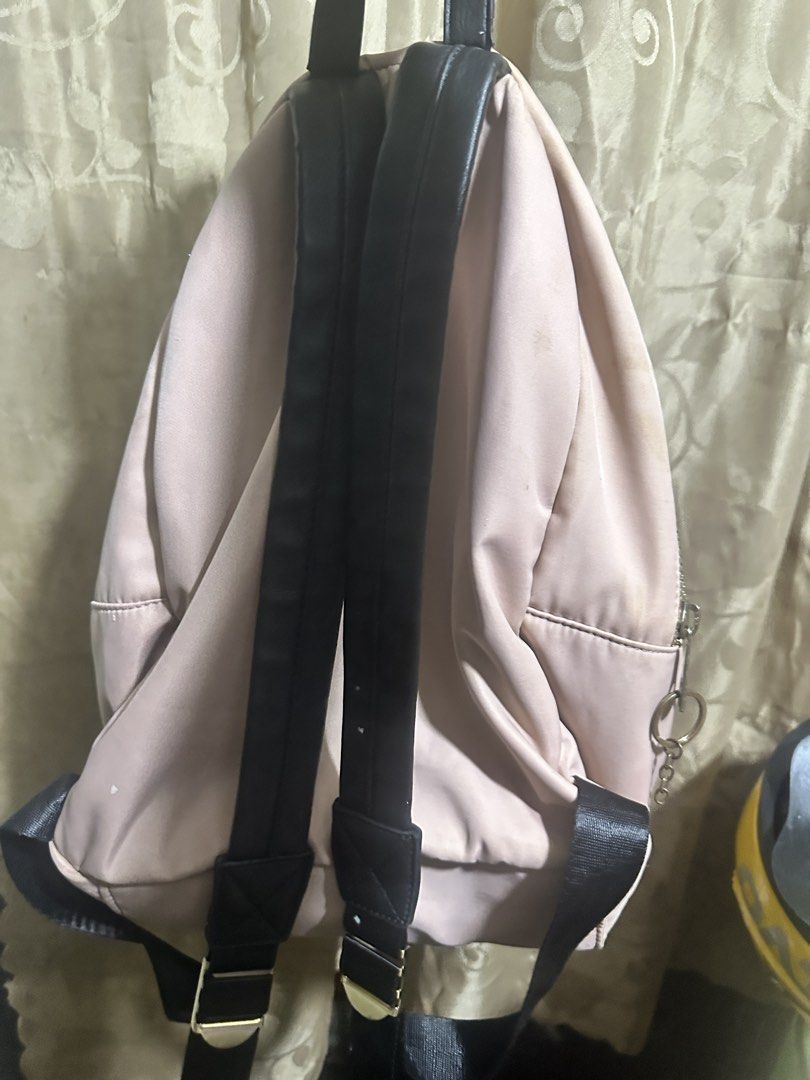 KissMe Couture Pink Backpack (Category: Backpacks) located in Manila. Submitted by edgiedge (Listing ID 1465060704, Image 3). Description: Chic pink nylon backpack featuring contrasting black straps, gold-tone hardware, and a cute front D-ring clasp. The interior boasts bright pink lining and a unique lips-shaped logo patch. Please note there are some white stains near the bottom and inside pocket. Perfect for casual everyday use! ₱200.