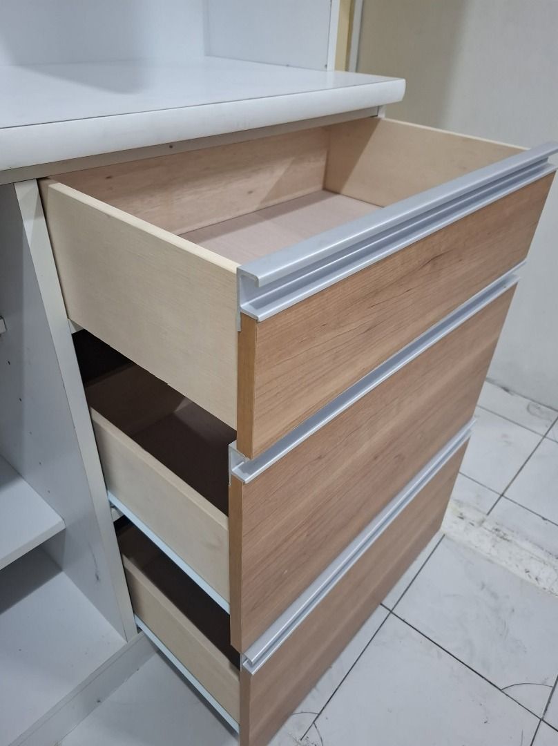 Kitchen storage hutch with upper cabinets and drawers (Category: Shelves, Cabinets & Racks) located in Quezon City. Submitted by japandemanila (Listing ID 1465005186, Image 2). Description: - Color/Material: White and light wood - Upper storage with doors - Convenient counter space - 3 pull-out drawers with modern aluminum handles - Lower cabinet section - Clean interior surfaces - Ideal for extra kitchen organization - Pickup only.
