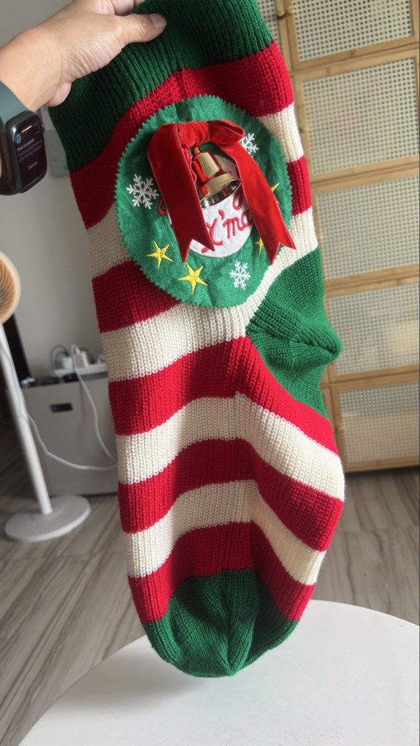 Knitted Christmas Stocking with Wreath and Bell (Category: Handmade Craft) located in Pasig City. Submitted by cecilececile4361 (Listing ID 1464995357, Image 3). Description: - Festive knitted Christmas stocking in red, white, and green stripes - Detailed with a circular felt wreath, embroidered 'Merry X'mas' text, gold stars, and white snowflakes - Accented with a bright red velvet bow and a secure golden bell - Made from thick, high-quality kni