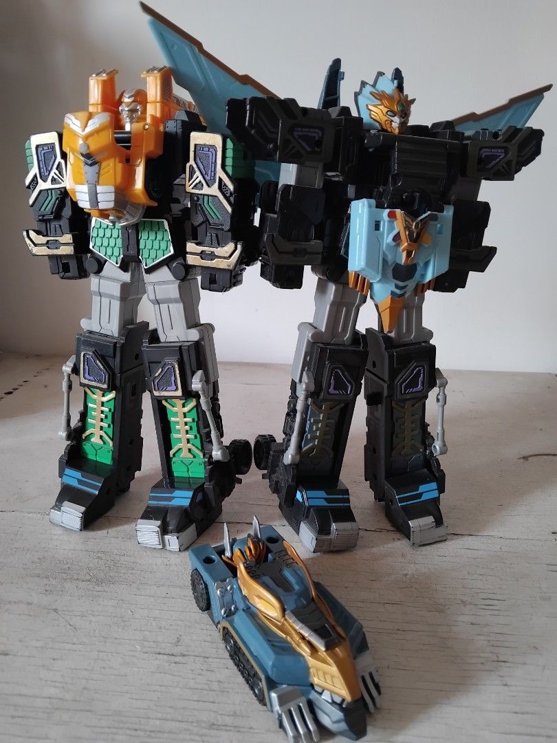 Korean Robot Toy (Category: Action & Battle Toys) located in San Fernando. Submitted by imlikeabird (Listing ID 1464970977, Image 1). Description: - Multi-colored transforming robot toy set with a large combined mecha and a separate smaller vehicle - Features a solid build made of durable black, grey, blue, and orange plastic parts - Equipped with articulated joints on the legs and torso for dynamic posing - Detailed armor pieces attached for an 