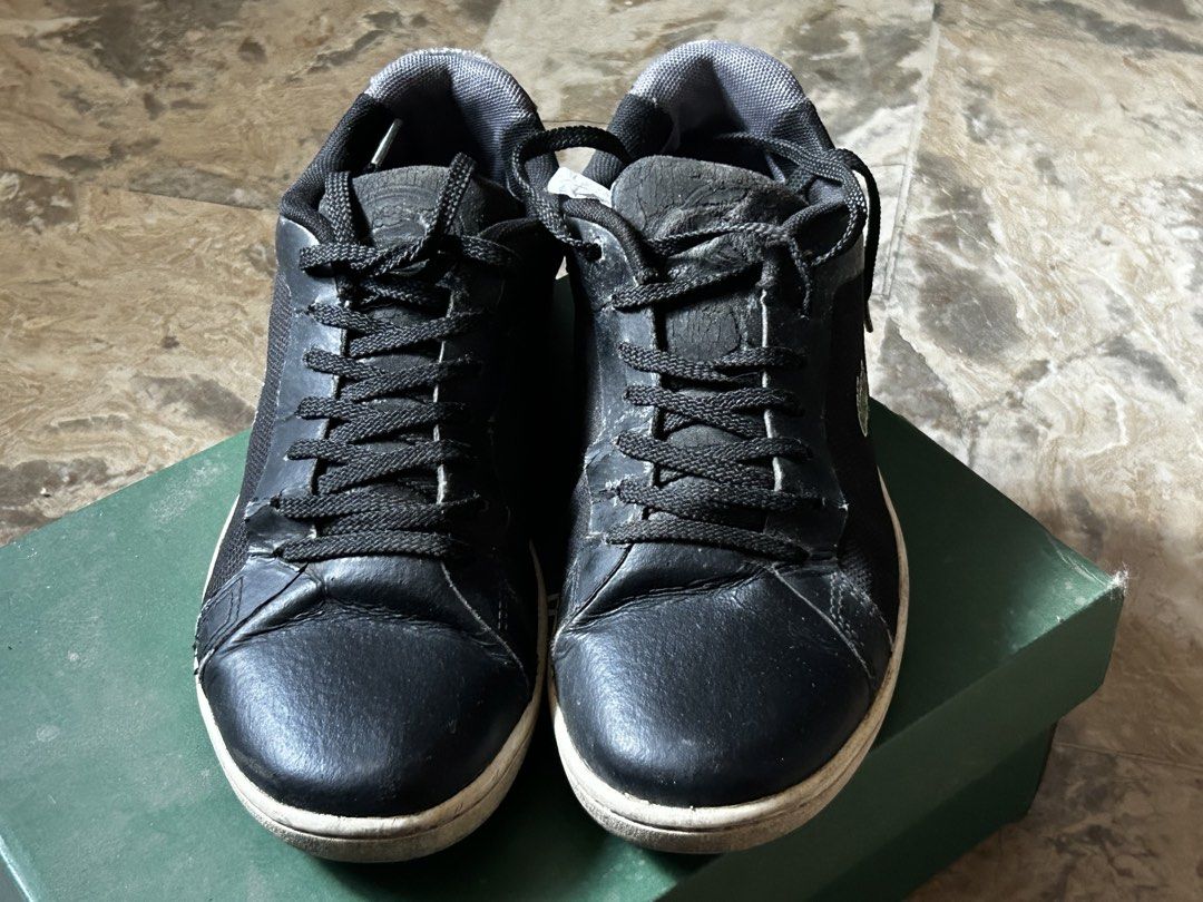 Lacoste Black Casual Sneakers (Category: Sneakers) located in Caloocan City. Submitted by ctrl12 (Listing ID 1465060507, Image 2). Description: - Size: US 5.5 / 22.5 cm - Brand: Lacoste - Color: Black with white soles and signature green crocodile logo - Material: Fabric and leather combination upper - Closure: Standard lace-up with black woven laces - Condition: Pre-owned with visible wear on the tongues and midsoles - Inclusion: Stuffing paper 