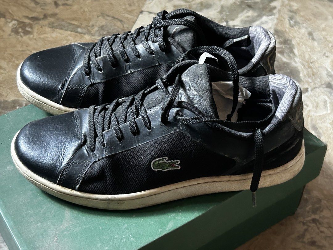 Lacoste Black Casual Sneakers (Category: Sneakers) located in Caloocan City. Submitted by ctrl12 (Listing ID 1465060507, Image 3). Description: - Size: US 5.5 / 22.5 cm - Brand: Lacoste - Color: Black with white soles and signature green crocodile logo - Material: Fabric and leather combination upper - Closure: Standard lace-up with black woven laces - Condition: Pre-owned with visible wear on the tongues and midsoles - Inclusion: Stuffing paper 
