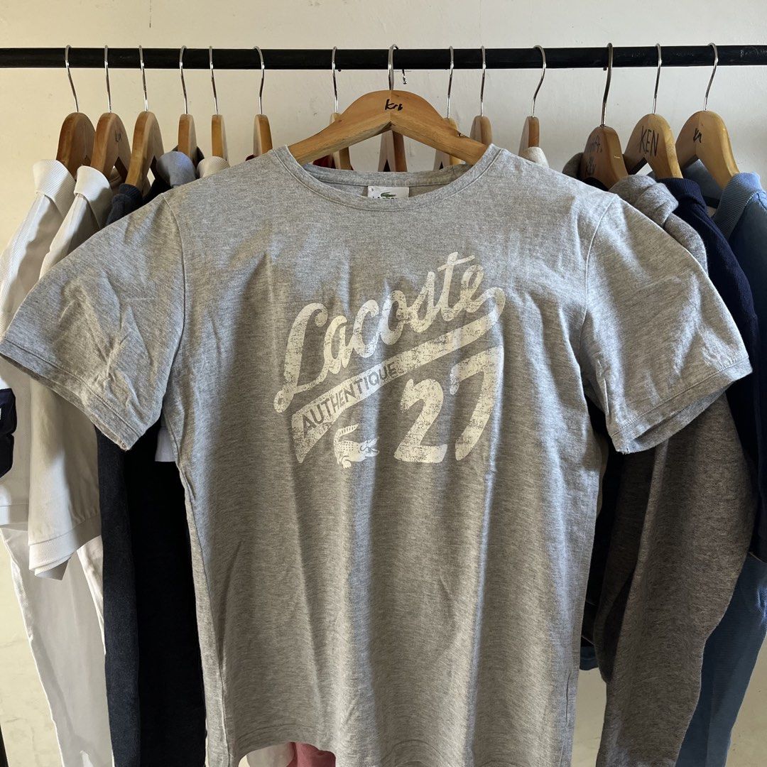 Lacoste Grey Graphic T-Shirt Size 3 (Category: Tshirts & Polo Shirts ) located in Sagbayan (Borja). Submitted by lunapawpaw46843 (Listing ID 1465048372, Image 1). Description: - Brand: Lacoste - Style: Crew neck tee with distressed front graphic - Size: 3 (fits standard) - Color: Grey - Material: Comfortable cotton blend - Design details: Large 'Authentique', '27', and logo print (distressing is part of original design) - Condition: Great everyda