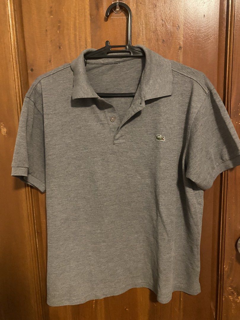 Lacoste Grey Polo Shirt (Category: Tshirts & Polo Shirts ) located in Las Pinas. Submitted by eastwest_ (Listing ID 1465002329, Image 1). Description: - Brand: Lacoste - Color: Grey - Style: Short-sleeve polo shirt with classic collar and two-button placket - Details: Signature embroidered crocodile logo on the left chest, ribbed cuffs and hem - Material: Comfortable, breathable knit fabric - Condition: Excellent / Well-maintained - Versatility: 