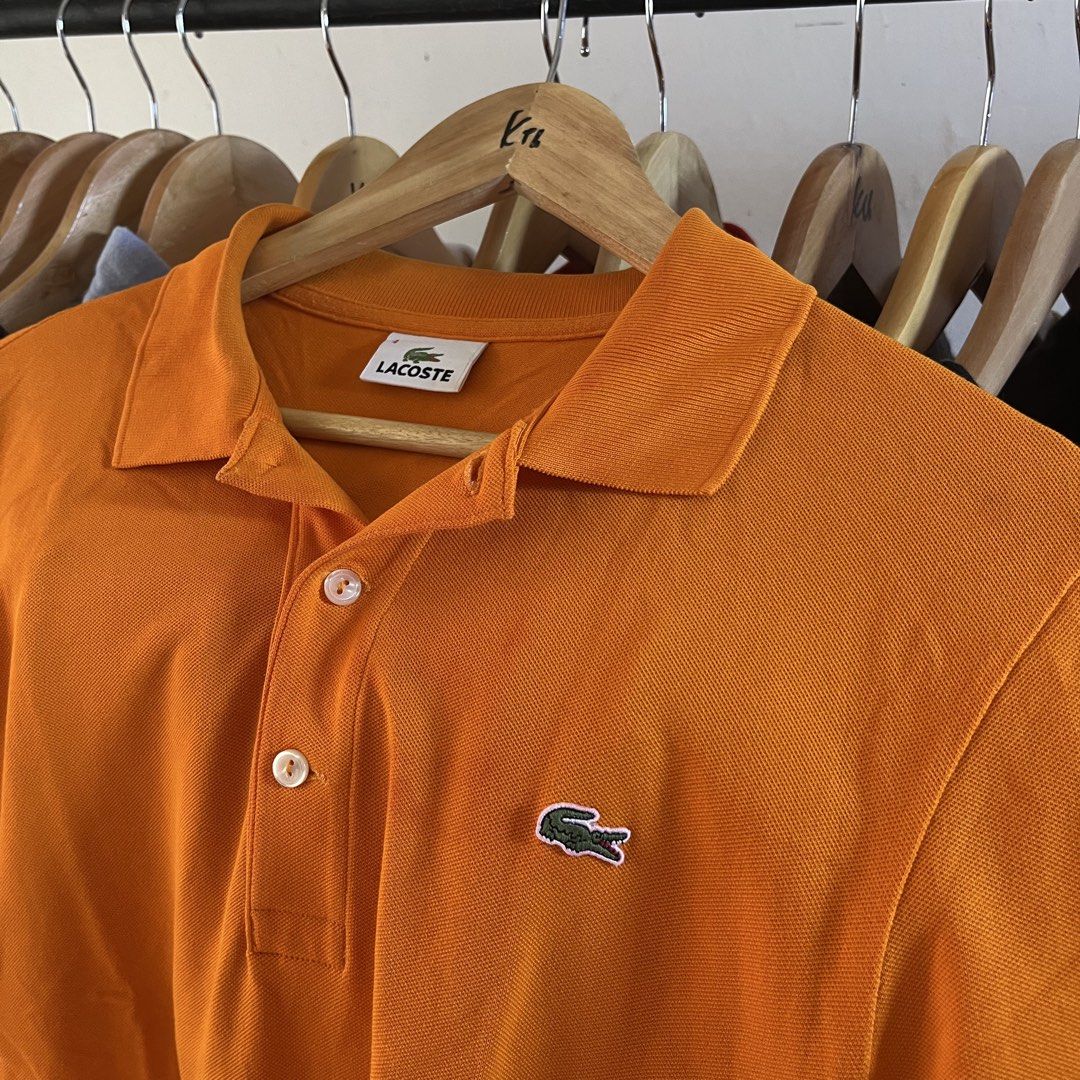 Lacoste Orange Polo Shirt Size 4 (Category: Tshirts & Polo Shirts ) located in Sagbayan (Borja). Submitted by lunapawpaw46843 (Listing ID 1465094597, Image 2). Description: - Brand: Lacoste - Color: Bright orange - Size: Men's 4 - Material: Classic cotton pique - Features: Two-button placket, standard collar, short sleeves, and embroidered green crocodile logo - Condition: Clean and ready to wear.