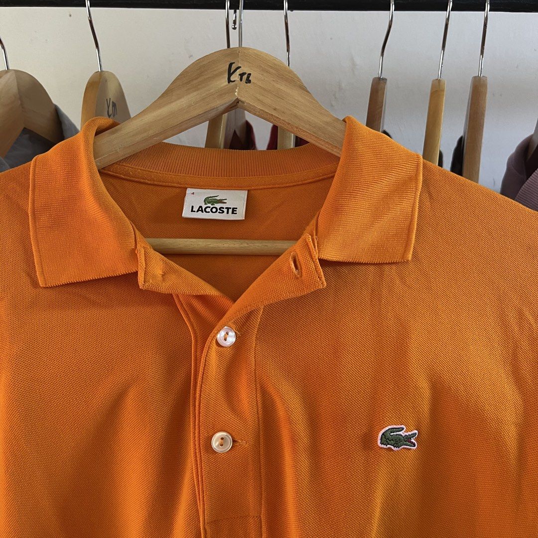 Lacoste Orange Polo Shirt Size 4 (Category: Tshirts & Polo Shirts ) located in Sagbayan (Borja). Submitted by lunapawpaw46843 (Listing ID 1465094597, Image 3). Description: - Brand: Lacoste - Color: Bright orange - Size: Men's 4 - Material: Classic cotton pique - Features: Two-button placket, standard collar, short sleeves, and embroidered green crocodile logo - Condition: Clean and ready to wear.