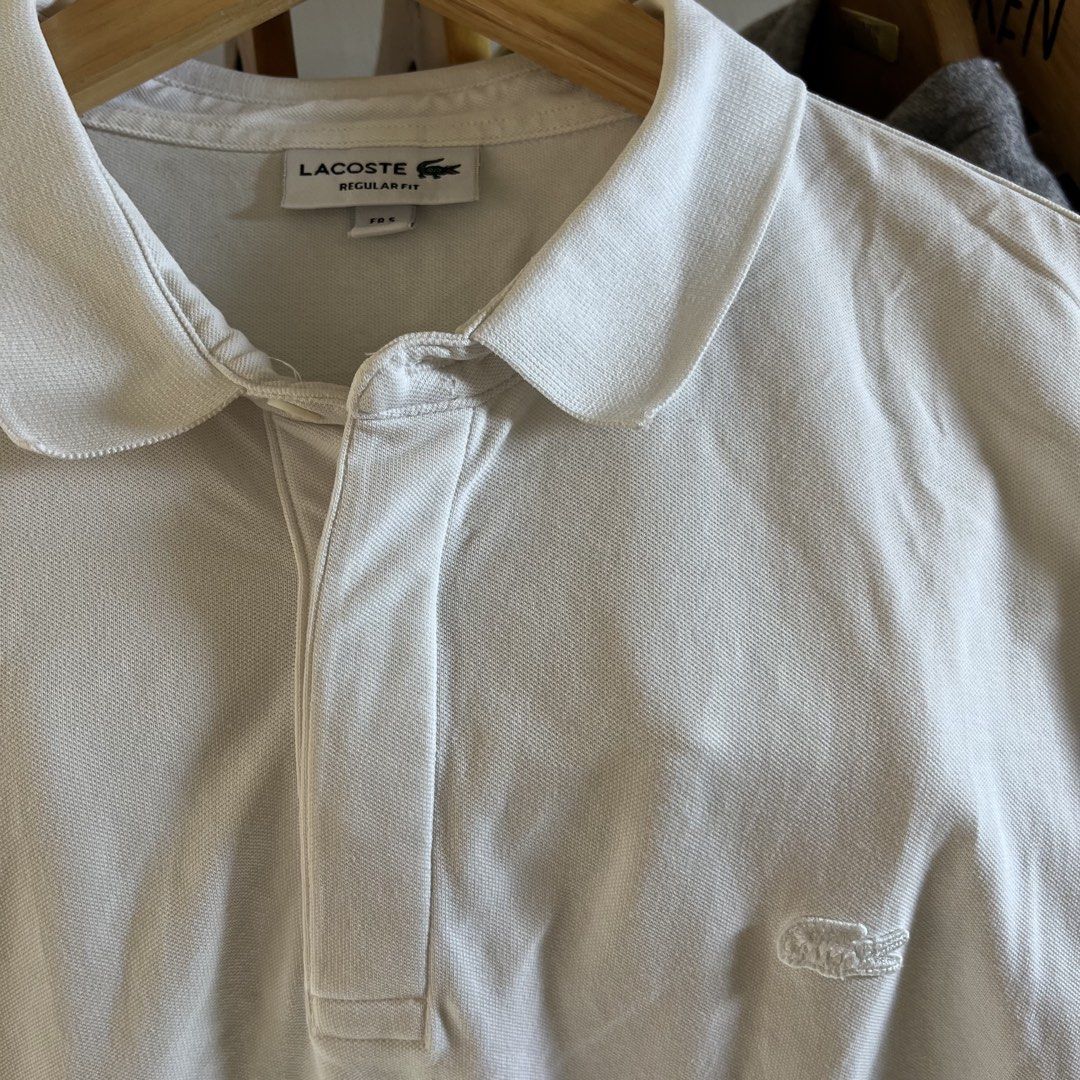 Lacoste Regular Fit White Polo Shirt (Category: Tshirts & Polo Shirts ) located in Sagbayan (Borja). Submitted by lunapawpaw46843 (Listing ID 1465049368, Image 3). Description: - Brand: Lacoste - Color: Classic White - Fit: Regular fit - Material: Premium cotton petit pique - Details: Collar neck, short button placket, tonal embroidered crocodile logo on chest - Condition: Excellent, from a clean wardrobe clearout - Styling: Versatile piece that 