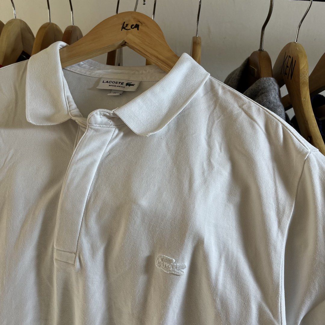 Lacoste Regular Fit White Polo Shirt (Category: Tshirts & Polo Shirts ) located in Sagbayan (Borja). Submitted by lunapawpaw46843 (Listing ID 1465049368, Image 2). Description: - Brand: Lacoste - Color: Classic White - Fit: Regular fit - Material: Premium cotton petit pique - Details: Collar neck, short button placket, tonal embroidered crocodile logo on chest - Condition: Excellent, from a clean wardrobe clearout - Styling: Versatile piece that 