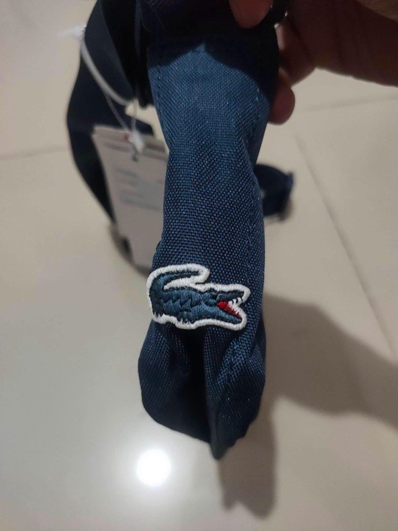 Lacoste sling bag w hang tag (Category: Luxury Bags & Wallets) located in General Trias. Submitted by luxfinds2019 (Listing ID 1464996884, Image 2). Description: Lacoste sling bag big logo 1700 Medium With hang tag No issue Loc laguna Pm .