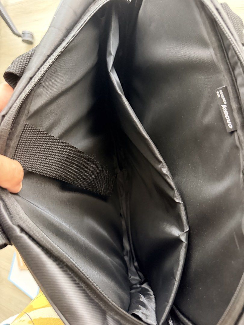 Laptop Bag Black (Category: Laptop Bags & Sleeves) located in Pasig City. Submitted by everythingbabiesandmore (Listing ID 1465050887, Image 3). Description: - specially designed for Lenovo laptops - Main zippered compartment includes a padded divider and securing strap for device safety - Convenient front zippered pocket featuring a stylish red pull tab detail - Comfortable dual top carry handles for easy transport - Crafted from a smooth, profe