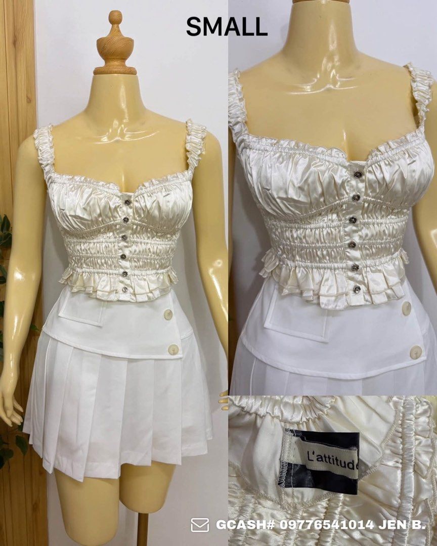 L'attitude White Satin Ruched Crop Top Small (Category: Sleeveless) located in Tagum. Submitted by bernardino49694 (Listing ID 1465010116, Image 1). Description: - Brand/Model: L'attitude Satin Crop Top - Color: White - Size: Small - Details: Ruched body, decorative button-down front, and cute ruffle trim at straps and hem - Fit: Comfortable smocked elastic back - Fabric: Soft, luxurious satin sheen.