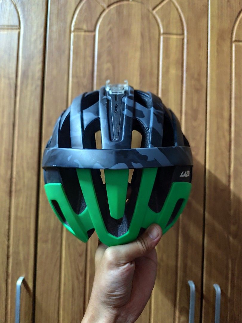 Lazer Revolution camouflage (Category: Bicycles) located in Manila. Submitted by roueljta84337 (Listing ID 1465012556, Image 3). Description: - Brand: Lazer Revolution - Design: Black and grey camo pattern with bright green inner section and branding - Included Accessories: Detachable ear guards - Condition: Used 4x only (bihira mag rides) - Features: Adjustable under-chin straps and sturdy construction for maximum cycling safety.