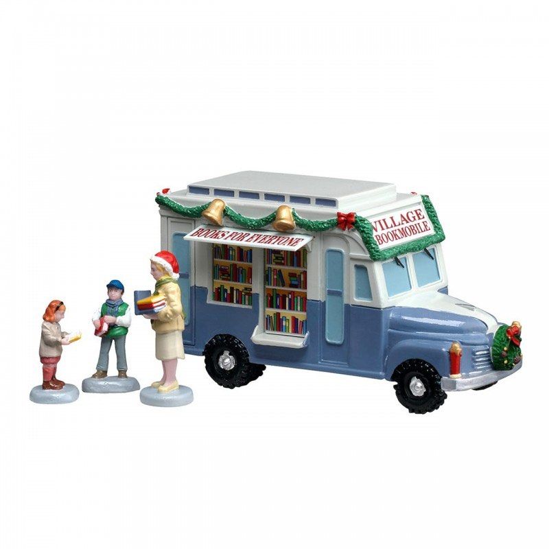 Lemax Bookmobile Christmas Village (Category: Designer & Blind Box Toys) located in Santiago. Submitted by kitalpanga (Listing ID 1465058015, Image 1). Description: - Festive blue and white bookmobile truck holiday village piece - Decorated with green garlands, bows, and bells on the roof - Side opens up to reveal display shelves filled with tiny books - Includes 3 adorable miniature figures: a woman holding books, a boy, and a small child readin